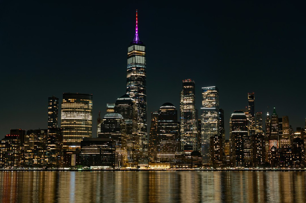 Financial district skyline lit up at night